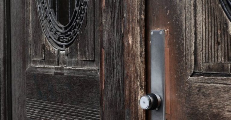 Damaged Lock - Closed old fashioned doors made of brown wood with damaged surface and metal handles