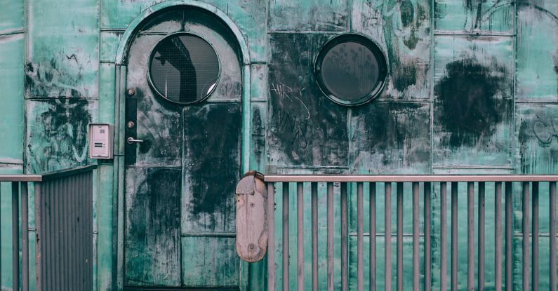 Lock Corrosion - Old shabby cabin with combination lock and round windows