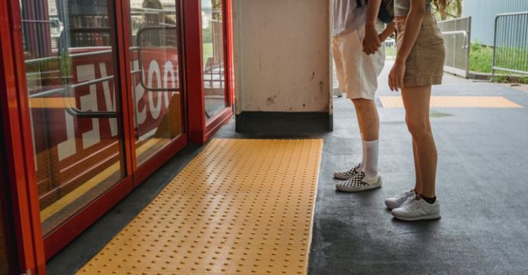 Access Control - Young couple holding hands while waiting for funicular