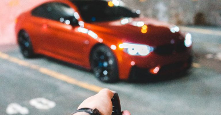 Car Key Remote - Crop person unlocking car in garage