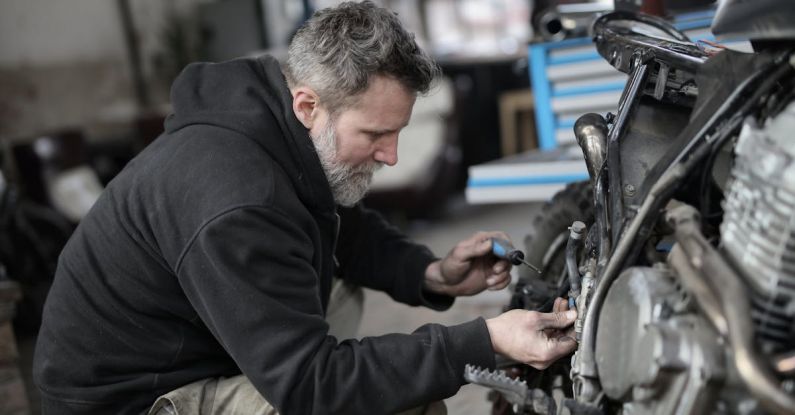 Master Key Systems - Bearded man fixing motorcycle in workshop