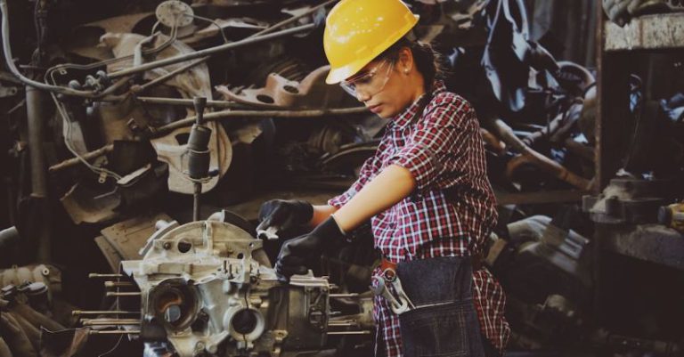 Lock Maintenance - Woman Wears Yellow Hard Hat Holding Vehicle Part