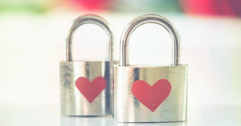 Biometric Locks - Bokeh Photo of Two Heart-printed Stainless Steel Padlocks