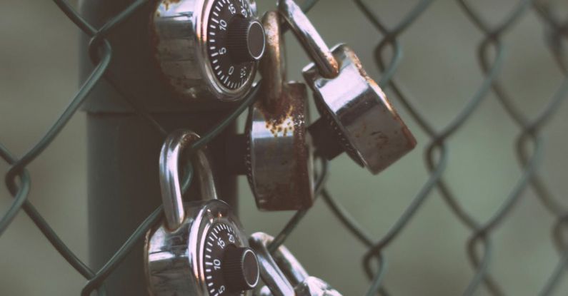 High-Security Locks - Silver Padlocks on Green Steel Fence