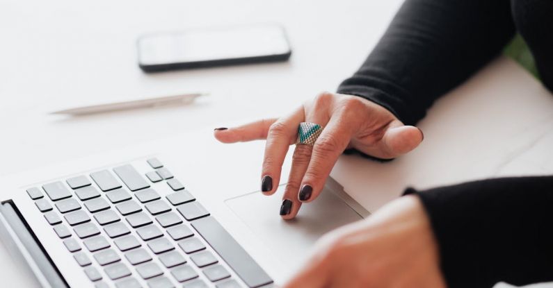 Smart Locks - Crop female using touchpad on laptop in office