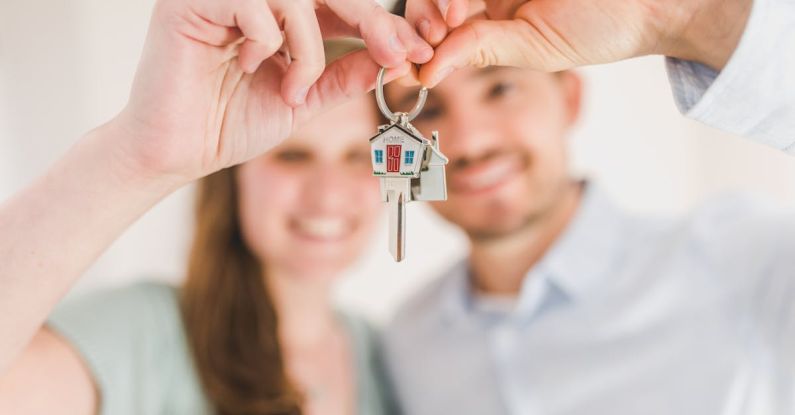 Key Fobs - Happy Couple Holding and Showing a House Key